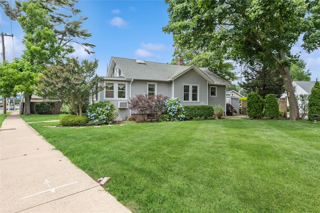 111 Little E Neck Rd, Babylon, NY 11702 - view of front of property with a front yard, a chimney, and roof with shingles