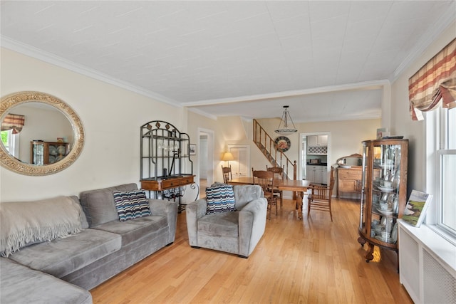 111 Little E Neck Rd, Babylon, NY 11702 - living area with radiator, light wood-style flooring, ornamental molding, and stairs