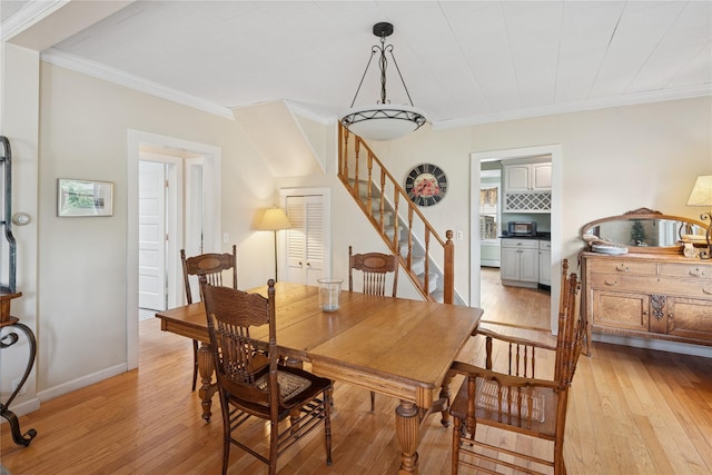 111 Little E Neck Rd, Babylon, NY 11702 - dining space featuring stairway, light wood-style floors, and ornamental molding