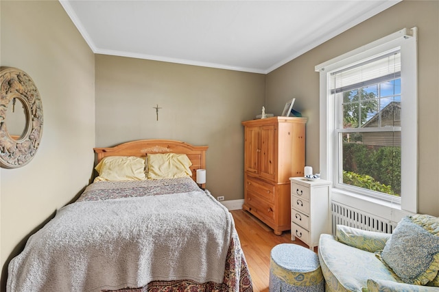 111 Little E Neck Rd, Babylon, NY 11702 - bedroom with crown molding, light wood-style flooring, and radiator