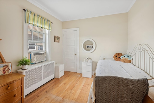 111 Little E Neck Rd, Babylon, NY 11702 - bedroom featuring radiator, light wood-type flooring, ornamental molding, and cooling unit