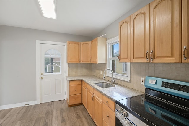 17 Schneider Ave, Highland Falls, NY 10928 - kitchen featuring stainless steel range with electric cooktop, light stone counters, light wood-style floors, light brown cabinetry, and backsplash