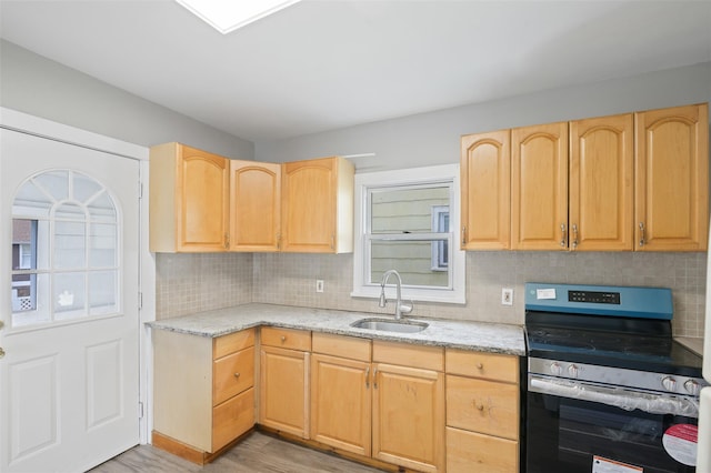 17 Schneider Ave, Highland Falls, NY 10928 - kitchen with stainless steel electric stove, light brown cabinets, light wood-style floors, and decorative backsplash