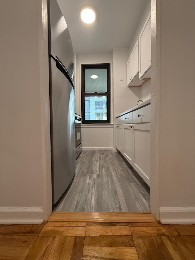98-10 64th Ave Unit 2E, Rego Park, NY 11374 - kitchen featuring white cabinetry, dark wood-style flooring, and stainless steel range oven