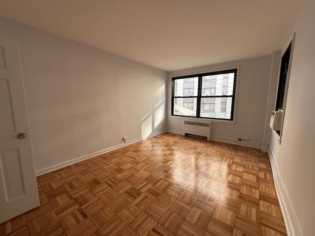 98-10 64th Ave Unit 2E, Rego Park, NY 11374 - spare room with radiator heating unit and baseboards