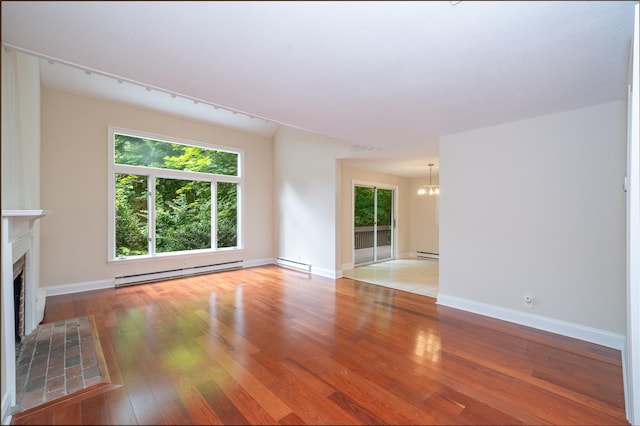 5 Grove Mews, Chappaqua, NY 10514 - unfurnished living room with baseboard heating, a chandelier, a tiled fireplace, and plenty of natural light