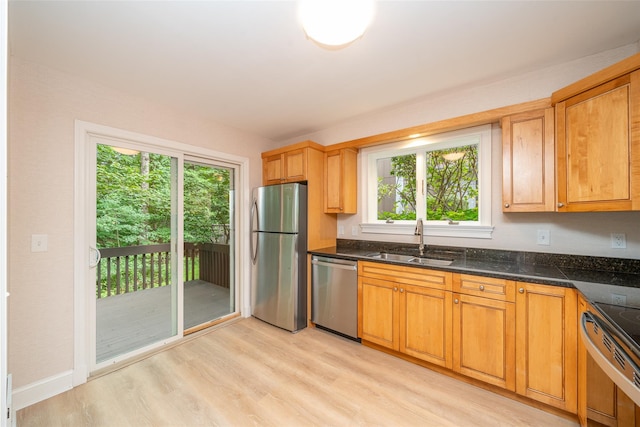 5 Grove Mews, Chappaqua, NY 10514 - kitchen with stainless steel appliances, light wood-type flooring, and dark stone countertops
