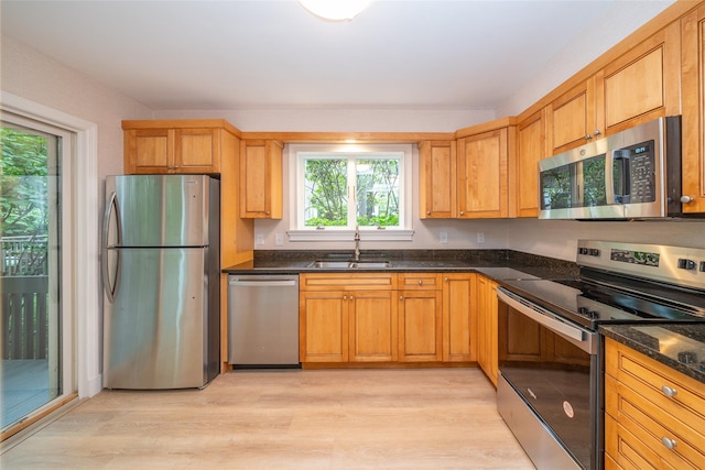 5 Grove Mews, Chappaqua, NY 10514 - kitchen with stainless steel appliances, light wood-style flooring, and dark stone countertops