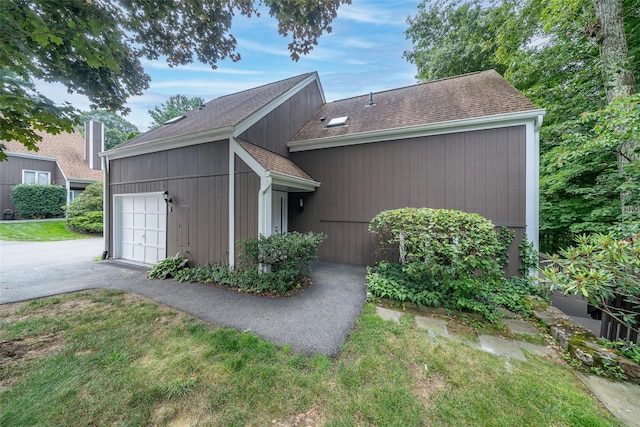 5 Grove Mews, Chappaqua, NY 10514 - view of property exterior featuring roof with shingles, an attached garage, and asphalt driveway