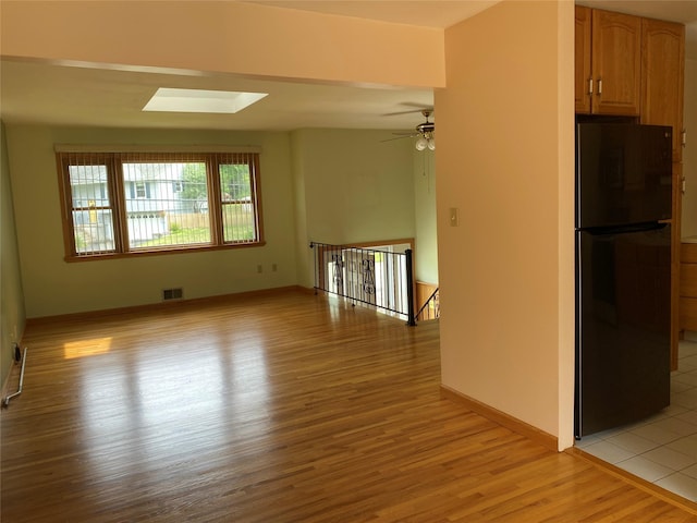 14 Shepard Rd, Warwick, NY 10990 - spare room featuring a skylight, light wood-style floors, and a ceiling fan