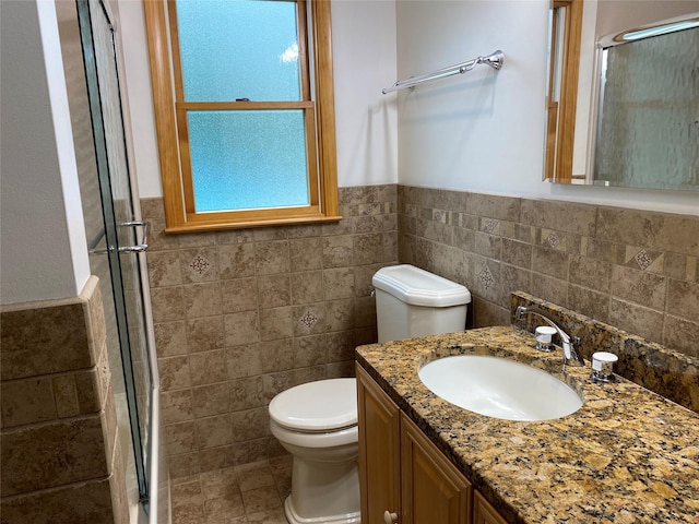 14 Shepard Rd, Warwick, NY 10990 - full bath featuring tile walls, a shower with shower door, a wainscoted wall, vanity, and tile patterned floors