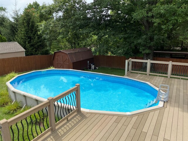 14 Shepard Rd, Warwick, NY 10990 - view of swimming pool with a wooden deck, a shed, and a fenced backyard