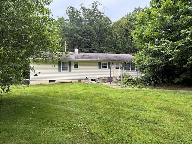 577 Wheeler Hill Rd, Wappingers Falls, NY 12590 - rear view of house featuring a lawn and a chimney