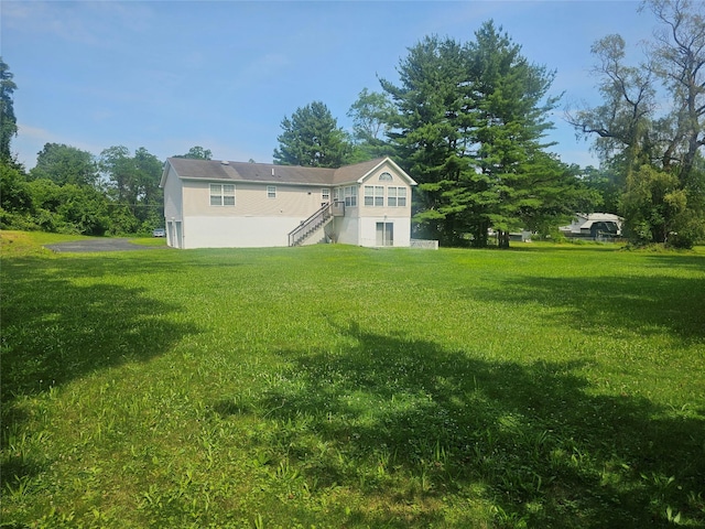 274 N Grand Ave, Poughkeepsie, NY 12603 - rear view of house featuring a yard and stairs