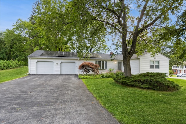 46 Laffin Ln, Poughkeepsie, NY 12603 - view of front of property featuring a garage, asphalt driveway, a front yard, roof mounted solar panels, and a chimney