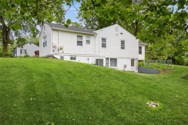 46 Laffin Ln, Poughkeepsie, NY 12603 - back of house with a vegetable garden and a lawn