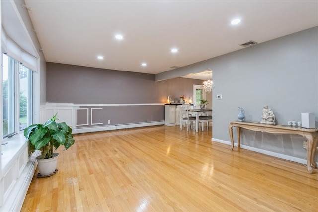 46 Laffin Ln, Poughkeepsie, NY 12603 - living area featuring baseboard heating, a chandelier, recessed lighting, and wood finished floors
