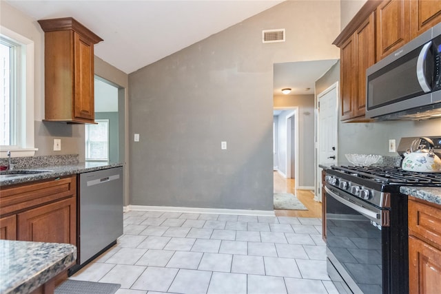 46 Laffin Ln, Poughkeepsie, NY 12603 - kitchen with appliances with stainless steel finishes, lofted ceiling, brown cabinetry, and healthy amount of natural light