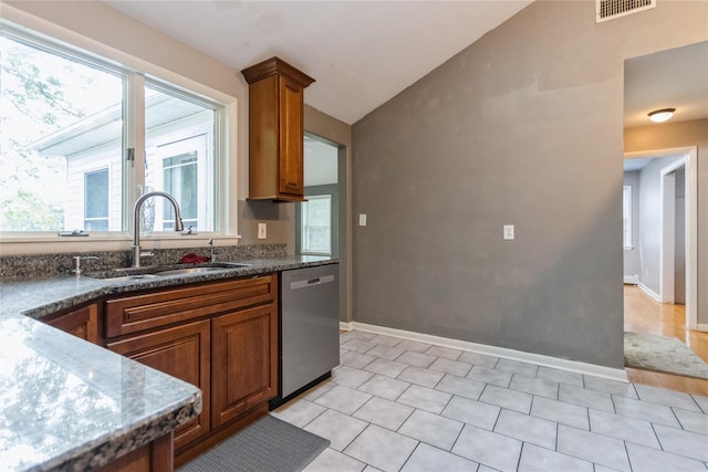 46 Laffin Ln, Poughkeepsie, NY 12603 - kitchen featuring dishwasher, lofted ceiling, brown cabinetry, and dark stone countertops
