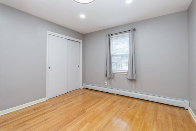 46 Laffin Ln, Poughkeepsie, NY 12603 - unfurnished bedroom with a baseboard radiator, wood finished floors, a closet, and recessed lighting