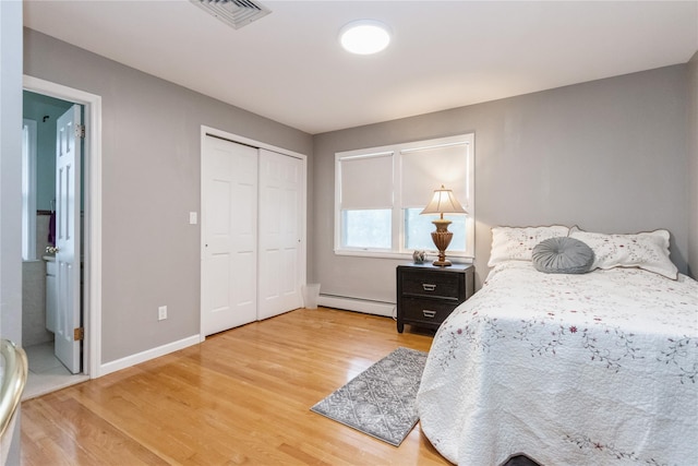 46 Laffin Ln, Poughkeepsie, NY 12603 - bedroom featuring a baseboard radiator, light wood-type flooring, a closet, and connected bathroom