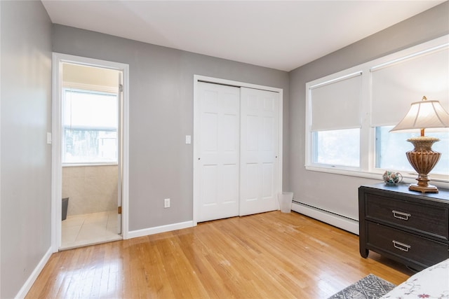 46 Laffin Ln, Poughkeepsie, NY 12603 - bedroom with a baseboard heating unit, light wood finished floors, multiple windows, and ensuite bathroom