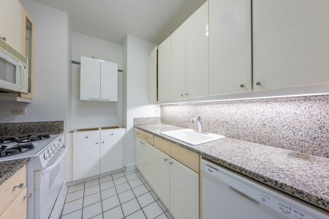 200 Riverside Blvd Unit 10C, New York Manhattan, NY 10069 - kitchen with white appliances, light tile patterned floors, white cabinets, and backsplash
