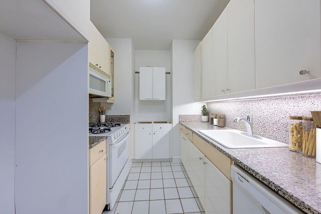200 Riverside Blvd Unit 10C, New York Manhattan, NY 10069 - kitchen featuring white appliances, backsplash, light tile patterned flooring, and white cabinets