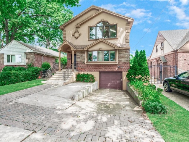 165-05 67th Ave, Fresh Meadows, NY 11365 - view of front of home with stucco siding, driveway, a garage, and brick siding