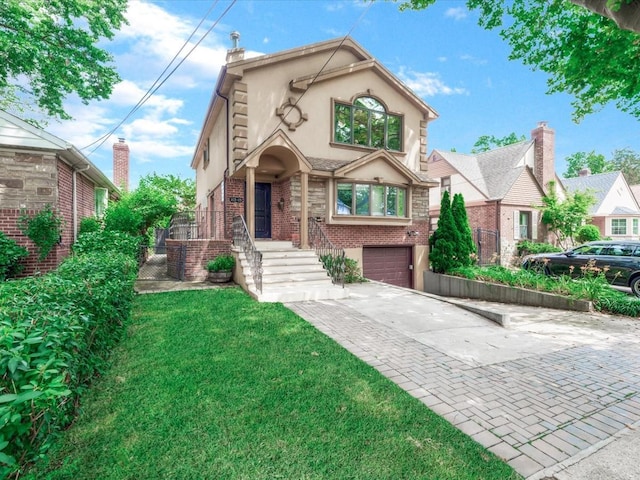165-05 67th Ave, Fresh Meadows, NY 11365 - view of front of home with stucco siding, driveway, brick siding, and an attached garage
