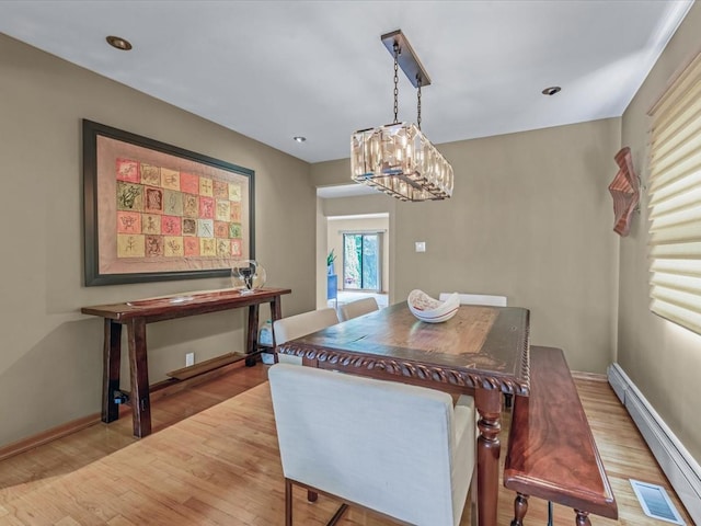 165-05 67th Ave, Fresh Meadows, NY 11365 - dining space featuring a baseboard heating unit, wood finished floors, and a chandelier