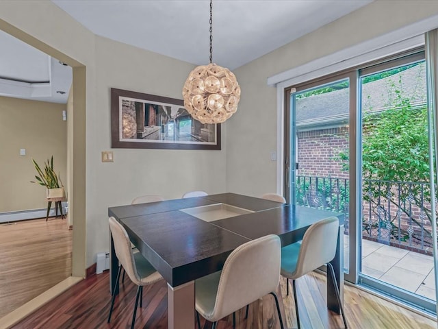 165-05 67th Ave, Fresh Meadows, NY 11365 - dining area with a baseboard radiator, wood finished floors, a chandelier, and a baseboard heating unit