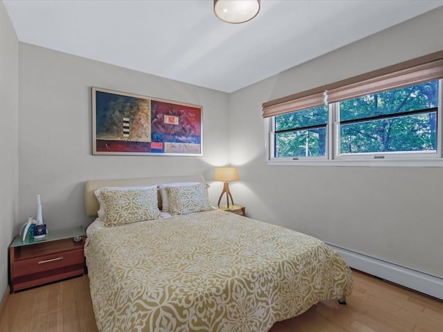 165-05 67th Ave, Fresh Meadows, NY 11365 - bedroom with a baseboard heating unit and wood finished floors