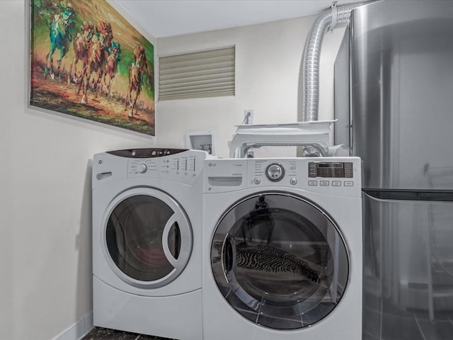 165-05 67th Ave, Fresh Meadows, NY 11365 - washroom featuring separate washer and dryer and baseboards
