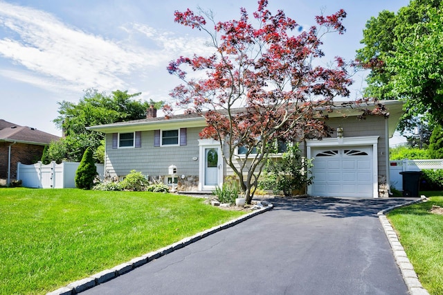 26 Comanche, Commack, NY 11725 - view of front of home featuring a chimney, driveway, a garage, and stone siding