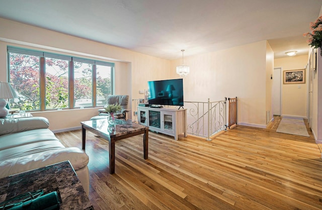 26 Comanche, Commack, NY 11725 - living area with light wood finished floors and a chandelier
