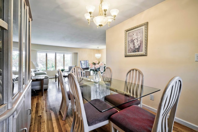 26 Comanche, Commack, NY 11725 - dining room with a chandelier and dark wood-style flooring