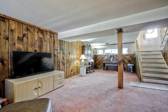 26 Comanche, Commack, NY 11725 - living room featuring wooden walls, carpet, and stairway