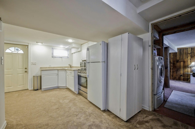 26 Comanche, Commack, NY 11725 - kitchen featuring stainless steel appliances, light carpet, white cabinets, light countertops, and washer / clothes dryer