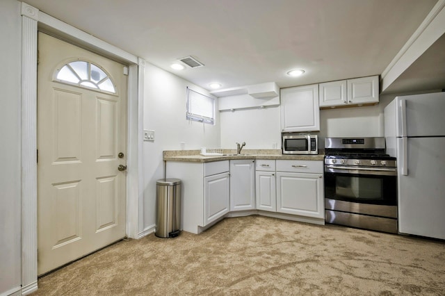 26 Comanche, Commack, NY 11725 - kitchen featuring stainless steel appliances, light carpet, white cabinets, light countertops, and recessed lighting