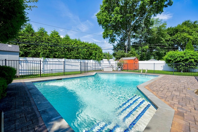 26 Comanche, Commack, NY 11725 - view of swimming pool featuring a fenced backyard, an outdoor structure, and a patio