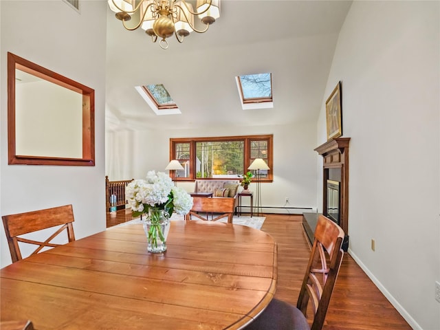 8 Dorset Rd, Call Listing Agent, CT 06851 - dining room with a baseboard radiator, a skylight, a chandelier, wood finished floors, and a glass covered fireplace