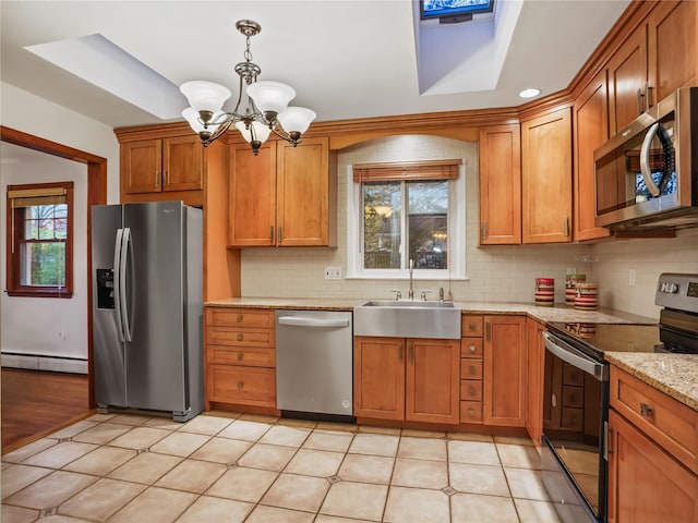8 Dorset Rd, Call Listing Agent, CT 06851 - kitchen with stainless steel appliances, a baseboard heating unit, a chandelier, and brown cabinetry