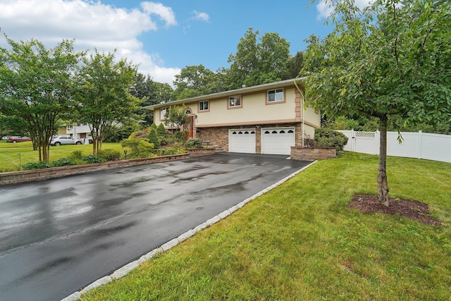 30 Birchwood Ter, Nanuet, NY 10954 - split foyer home featuring a garage, asphalt driveway, and stucco siding