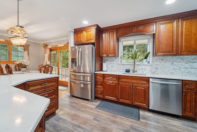 30 Birchwood Ter, Nanuet, NY 10954 - kitchen featuring appliances with stainless steel finishes, light countertops, backsplash, brown cabinets, and light wood-style flooring