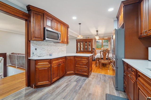 30 Birchwood Ter, Nanuet, NY 10954 - kitchen featuring appliances with stainless steel finishes, light wood-type flooring, light countertops, crown molding, and backsplash