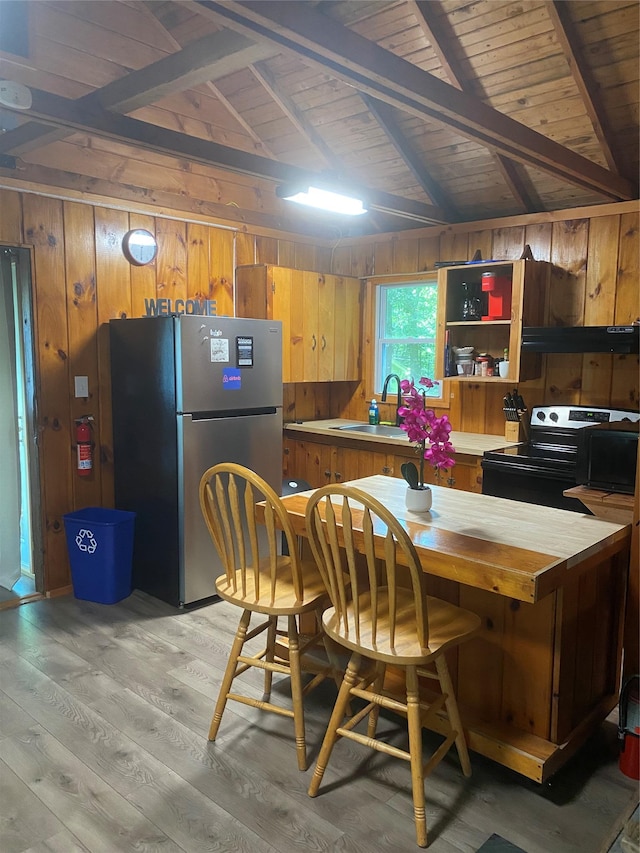 55 Woodcrest Dr, Middletown, NY 10940 - kitchen featuring electric range oven, freestanding refrigerator, wooden walls, light wood-style flooring, and wood ceiling