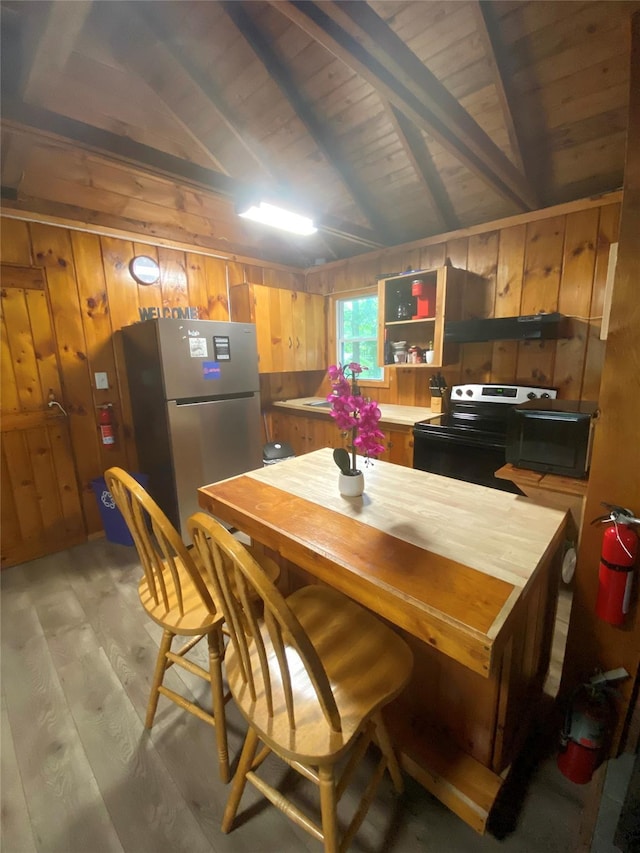 55 Woodcrest Dr, Middletown, NY 10940 - kitchen with black electric range, freestanding refrigerator, light wood-style flooring, wood walls, and wooden ceiling