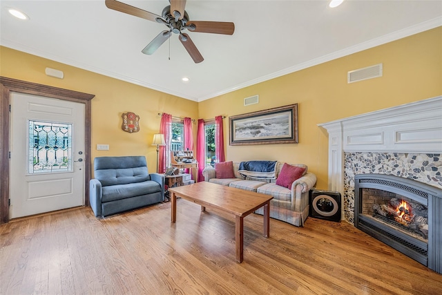 1025 Harrison Dr, Centerport, NY 11721 - living area featuring light wood-style flooring, ceiling fan, a tiled fireplace, ornamental molding, and recessed lighting