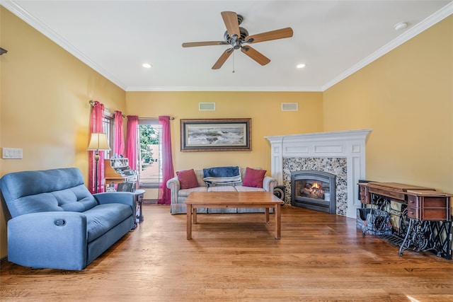 1025 Harrison Dr, Centerport, NY 11721 - living area with ceiling fan, wood finished floors, crown molding, a tiled fireplace, and recessed lighting